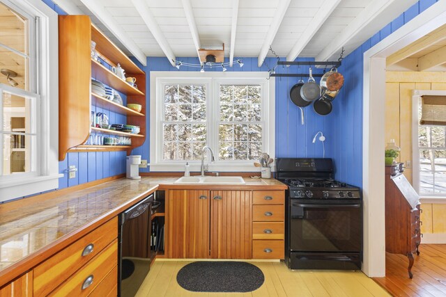 kitchen featuring sink, beam ceiling, black appliances, and light wood-type flooring