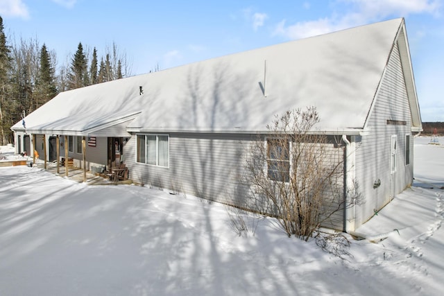 view of snow covered rear of property