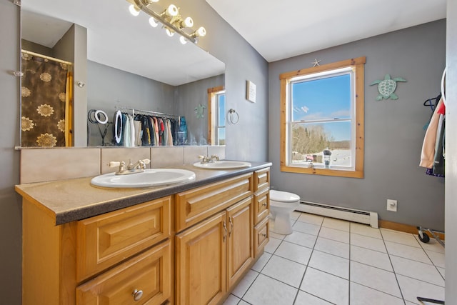 bathroom featuring a baseboard radiator, vanity, toilet, and tile patterned flooring