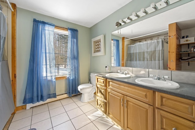 bathroom featuring vanity, a baseboard heating unit, tile patterned floors, and toilet