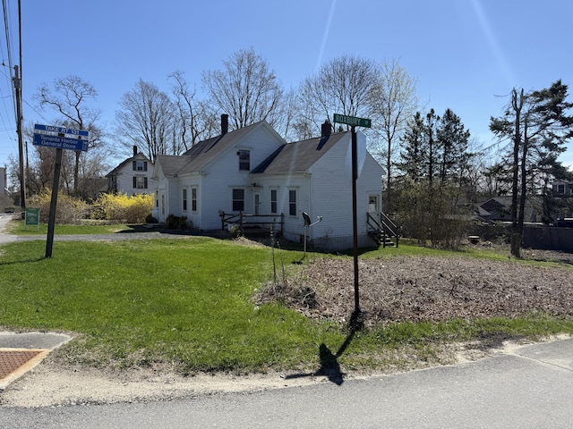 52 Main St, Thomaston, ME 04861 - view of home's exterior with a chimney and a yard