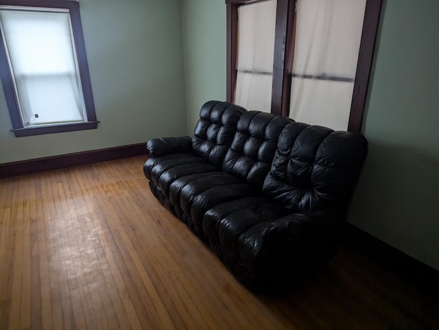 living room with wood-type flooring and baseboards