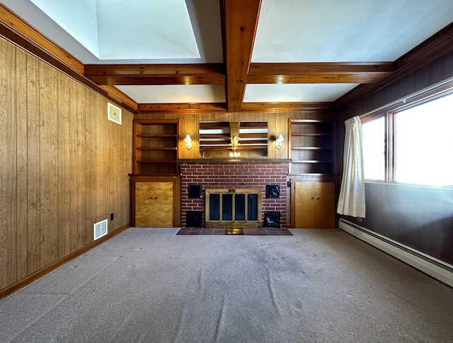 unfurnished living room featuring built in shelves, a baseboard heating unit, and wood walls