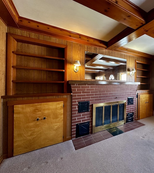 unfurnished living room featuring beam ceiling, carpet, built in features, and a fireplace