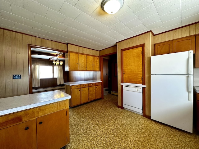 kitchen with a baseboard heating unit, white appliances, and wooden walls