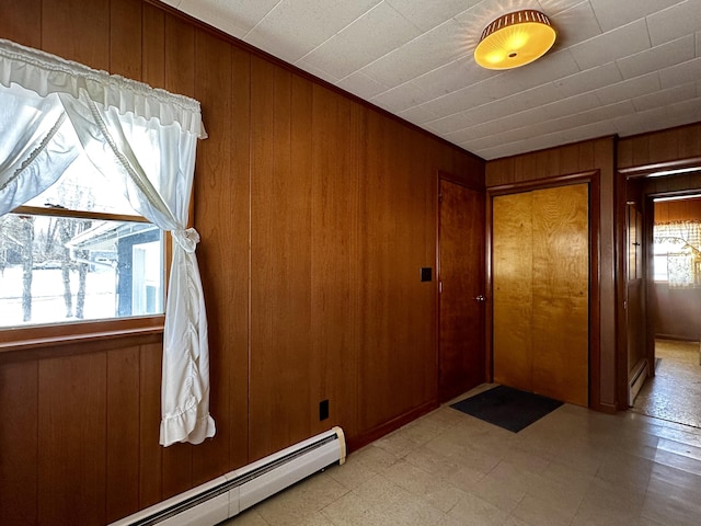 entryway featuring wooden walls and baseboard heating