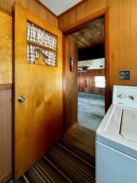 washroom with washer / clothes dryer, wooden walls, and ornamental molding