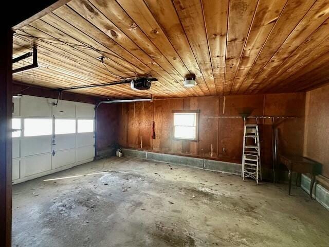 garage featuring a garage door opener and wooden ceiling