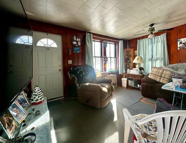 living room featuring wood walls