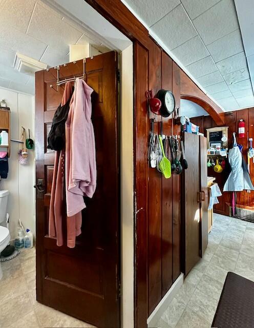 mudroom with wooden walls