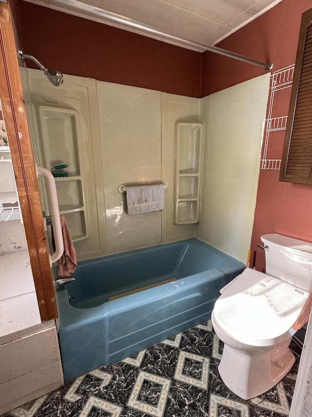 bathroom featuring shower / washtub combination and toilet