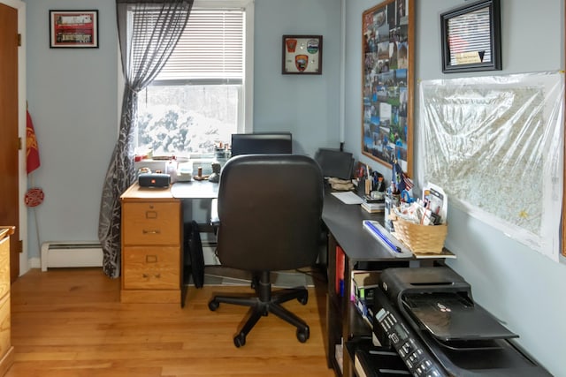 office area with baseboard heating and light hardwood / wood-style flooring