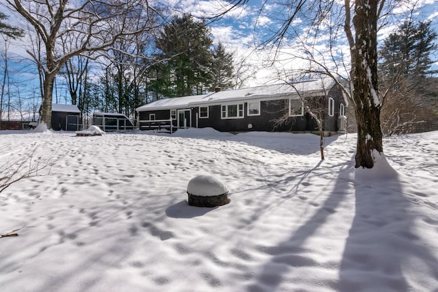 view of snow covered rear of property