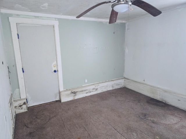 carpeted empty room featuring ceiling fan