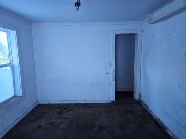 spare room with dark carpet