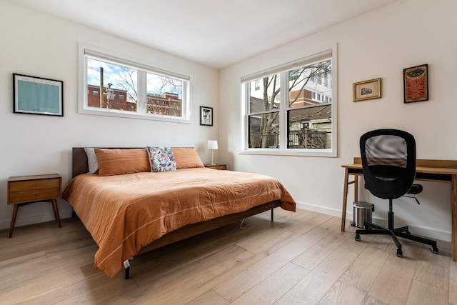 bedroom featuring light wood-type flooring and baseboards