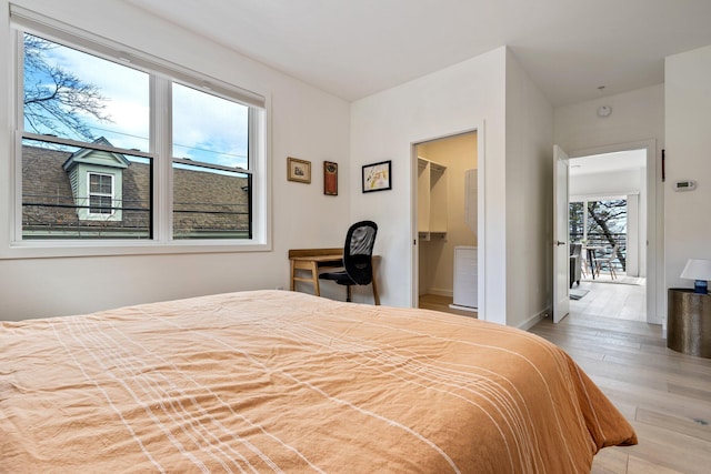 bedroom featuring baseboards and wood finished floors