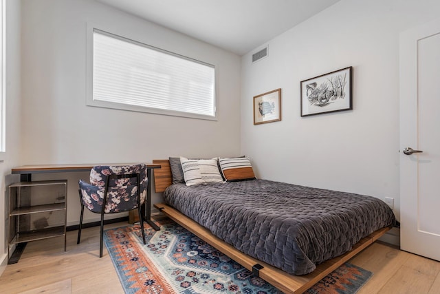 bedroom featuring light wood-type flooring and visible vents