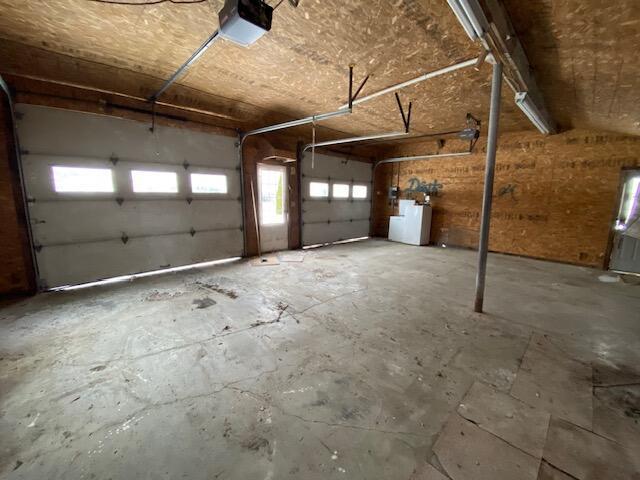 garage with a garage door opener and washer / dryer