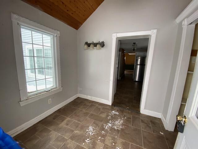 interior space featuring lofted ceiling and wooden ceiling