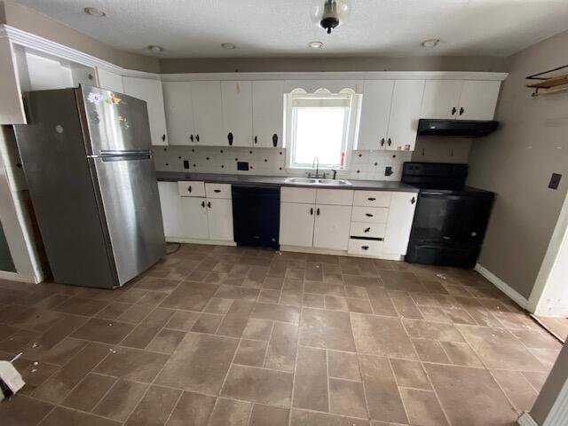 kitchen featuring sink, extractor fan, black appliances, white cabinets, and decorative backsplash