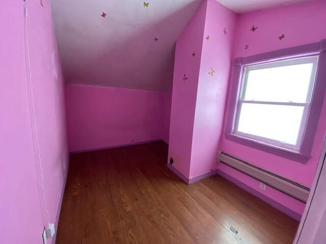 bonus room featuring lofted ceiling, a baseboard heating unit, and hardwood / wood-style floors