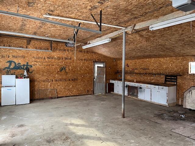 garage with white refrigerator and a garage door opener