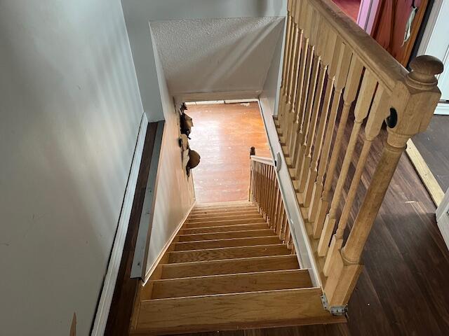 stairs with a textured ceiling