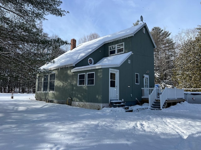 view of snow covered back of property