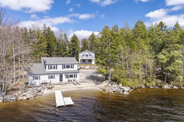 back of house featuring a patio and a water view