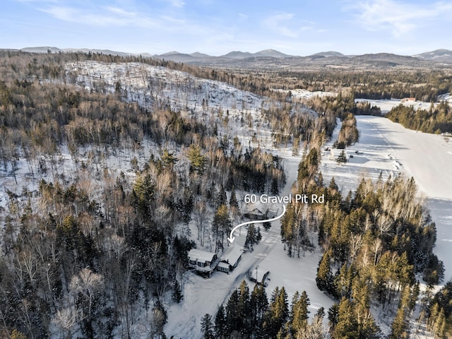 snowy aerial view with a mountain view