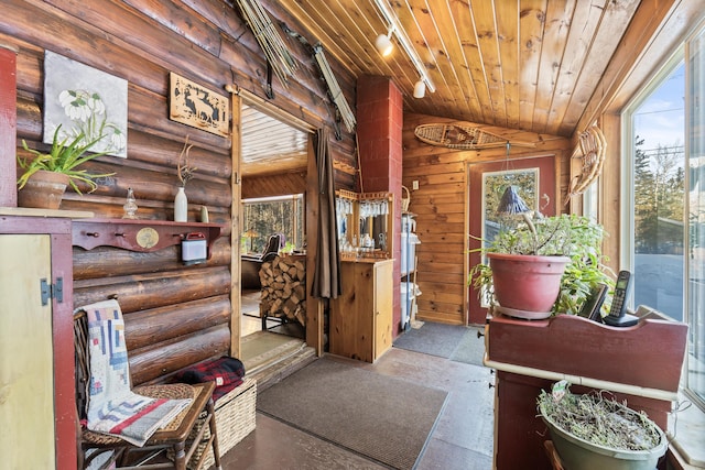 interior space with log walls, lofted ceiling, and wooden ceiling