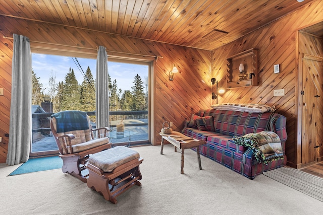 sitting room featuring carpet, wood ceiling, and wood walls