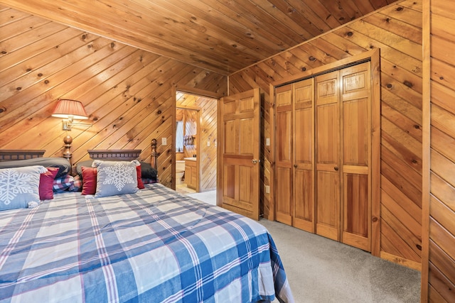 unfurnished bedroom with carpet floors, wooden ceiling, a closet, and wood walls