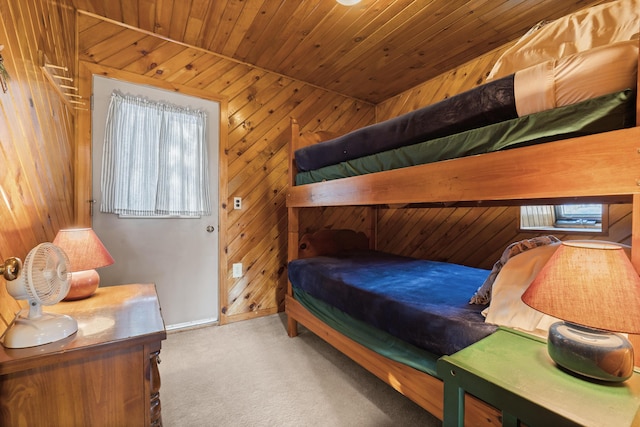 carpeted bedroom featuring wood ceiling and wooden walls