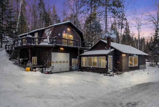 view of front of property with a garage and a deck