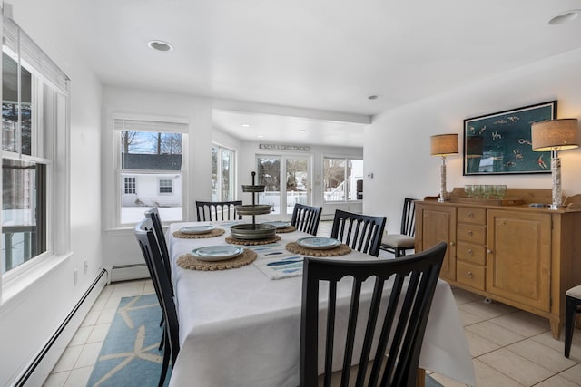 dining area with baseboard heating, a wealth of natural light, and light tile patterned flooring