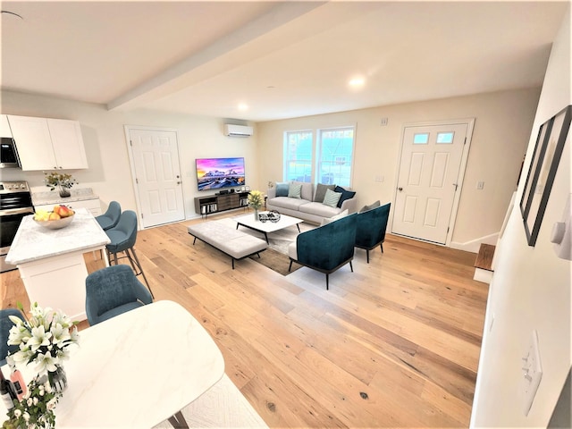 living room with beam ceiling, a wall mounted air conditioner, and light hardwood / wood-style floors