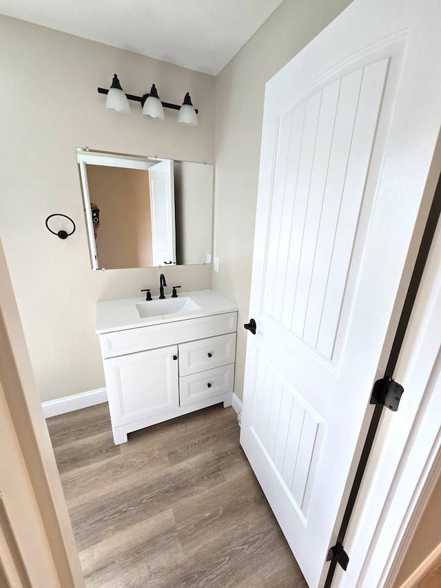 bathroom featuring hardwood / wood-style flooring and vanity