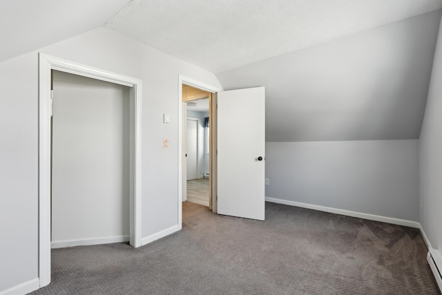 additional living space featuring lofted ceiling, carpet floors, a textured ceiling, and baseboard heating