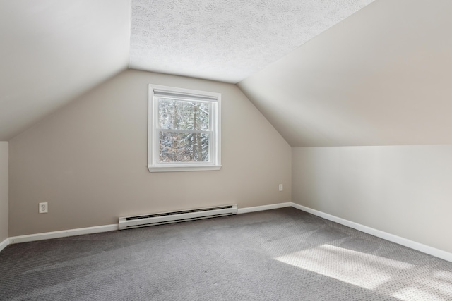 additional living space with a baseboard radiator, carpet floors, vaulted ceiling, and a textured ceiling