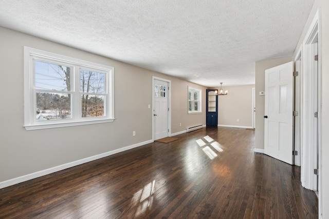 interior space with dark hardwood / wood-style flooring, a notable chandelier, a baseboard radiator, and a textured ceiling