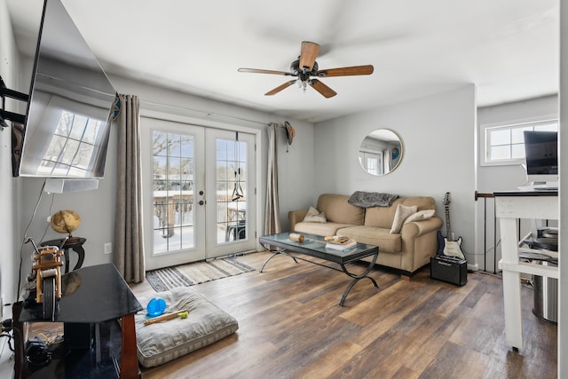 living room with dark wood-type flooring, ceiling fan, and french doors