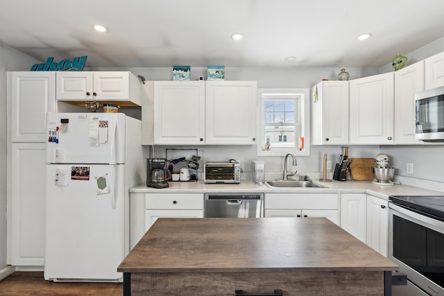 kitchen featuring appliances with stainless steel finishes, sink, and white cabinets