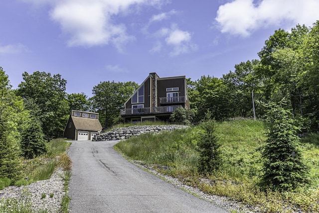 40 Skyline Dr, Holden, ME 04429 - a-frame style home with asphalt driveway and an attached garage