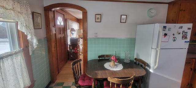 dining room featuring tile walls