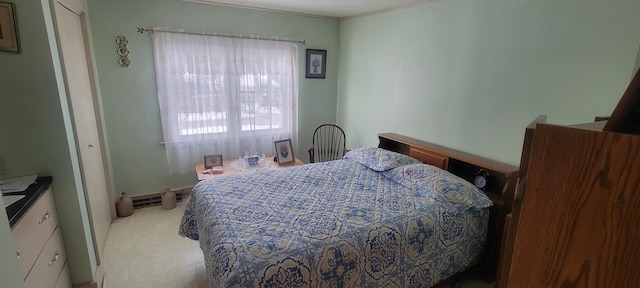 bedroom featuring crown molding and a baseboard radiator