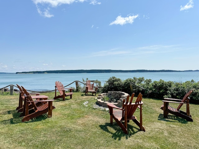 view of yard with a water view and a fire pit