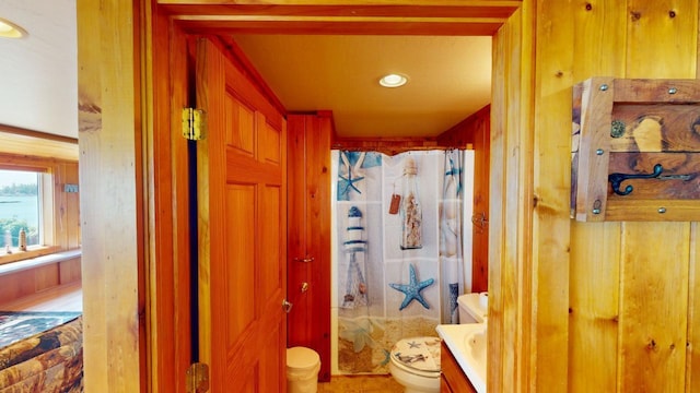 bathroom with vanity, toilet, and walk in shower