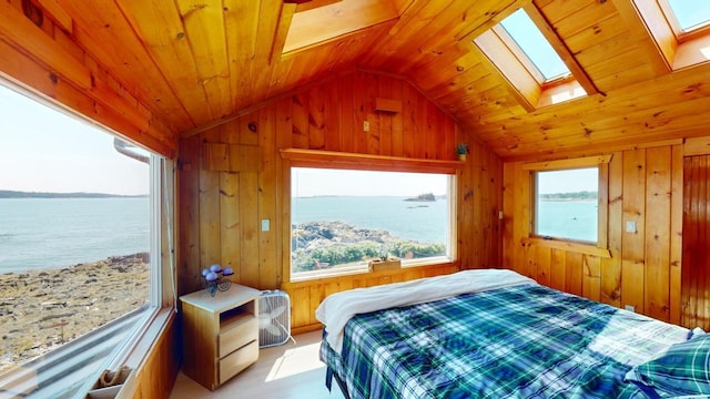 bedroom with a water view, wooden ceiling, wooden walls, and lofted ceiling with skylight